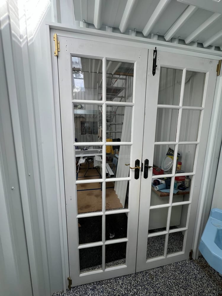The same french doors from inside the room, closed and finished