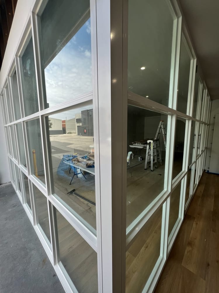 Close view along the glazed partition showing the framing joints and glass panels