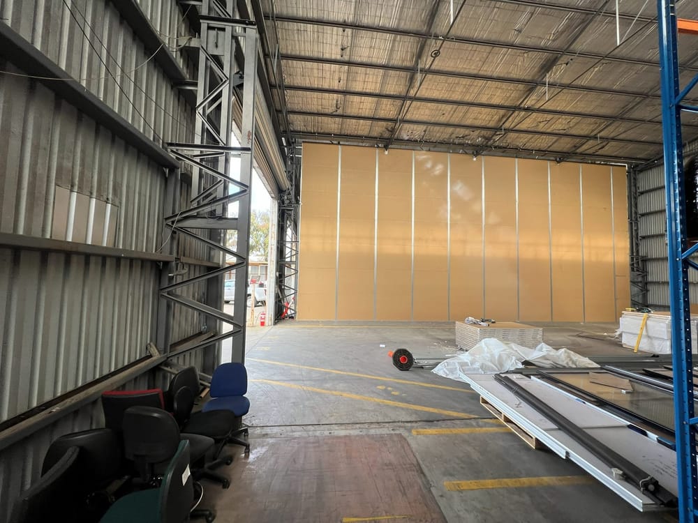 The completed dividing partition, sheeted and finished, inside the warehouse