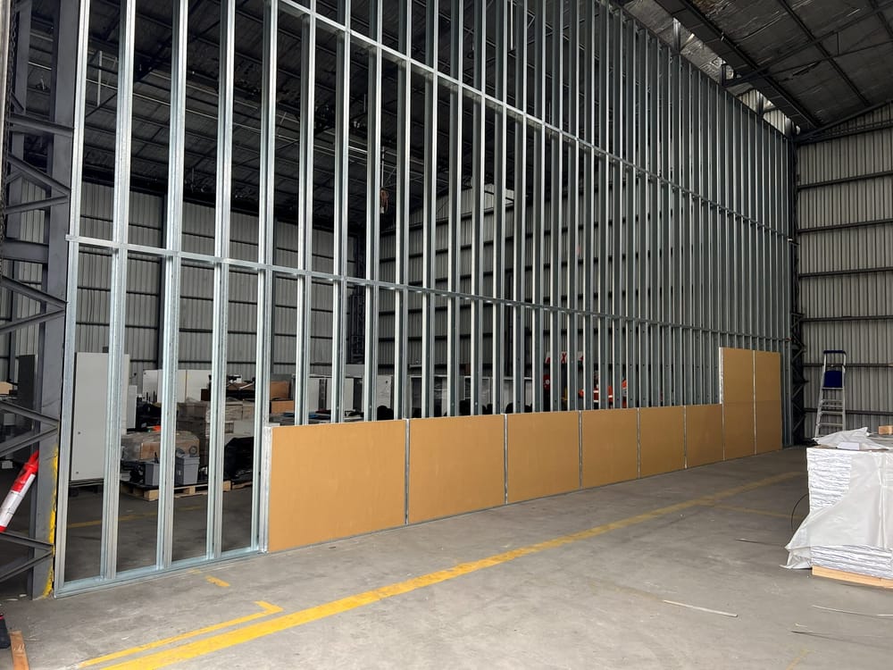 Steel stud framing for a full-height dividing partition inside a warehouse