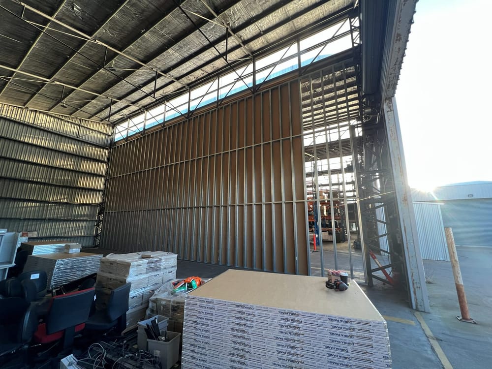 Dividing partition part-sheeted, with lining panels going on over the framing