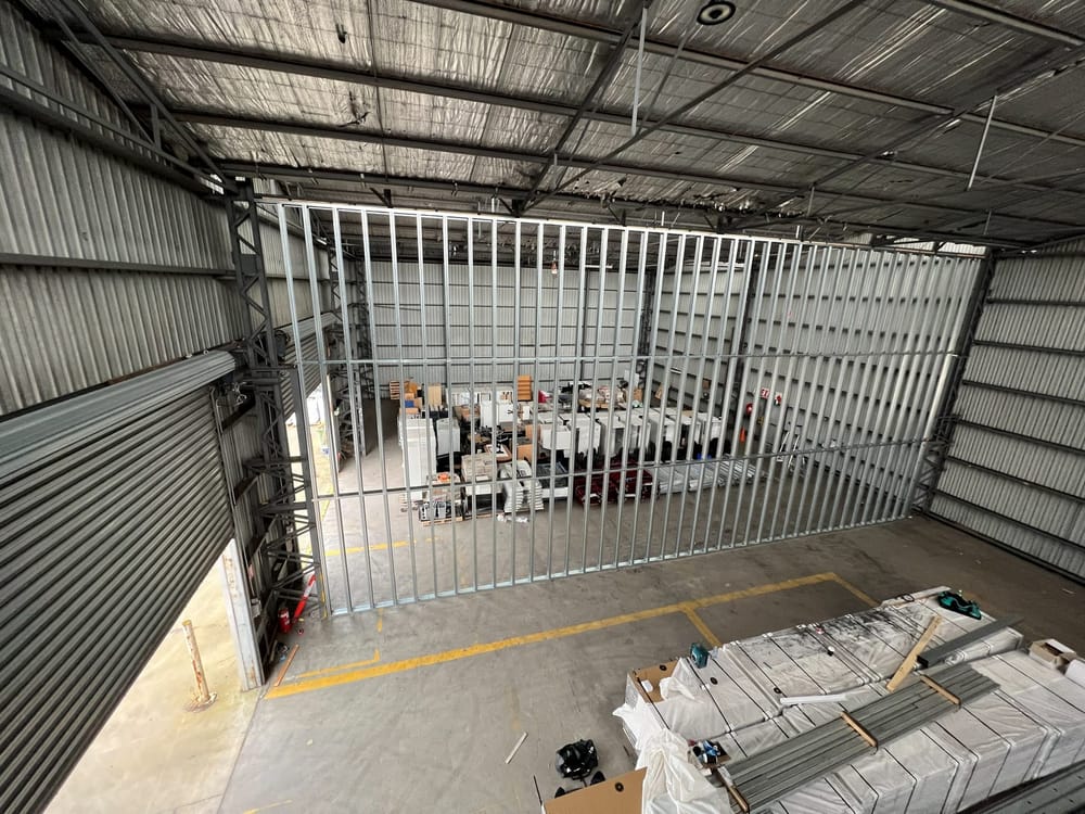 Steel stud framing started for a dividing wall in an empty warehouse unit