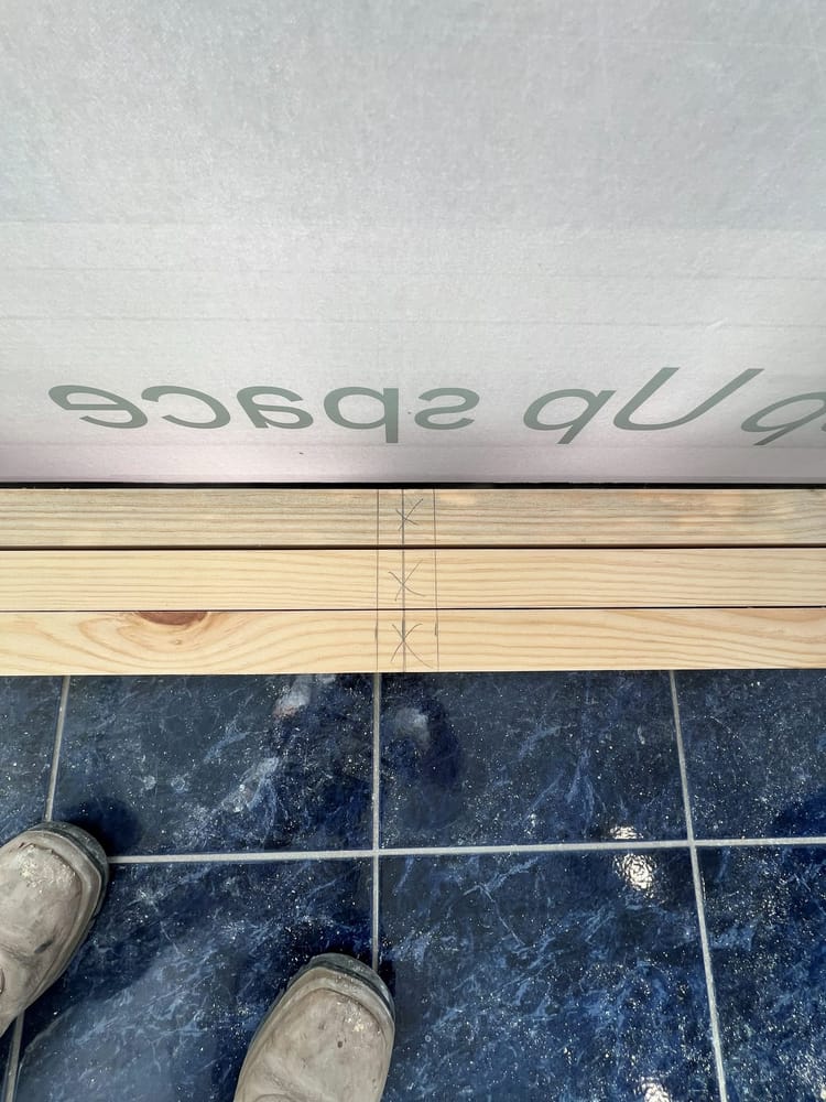 Timber set out on the floor of a tenancy before installation begins