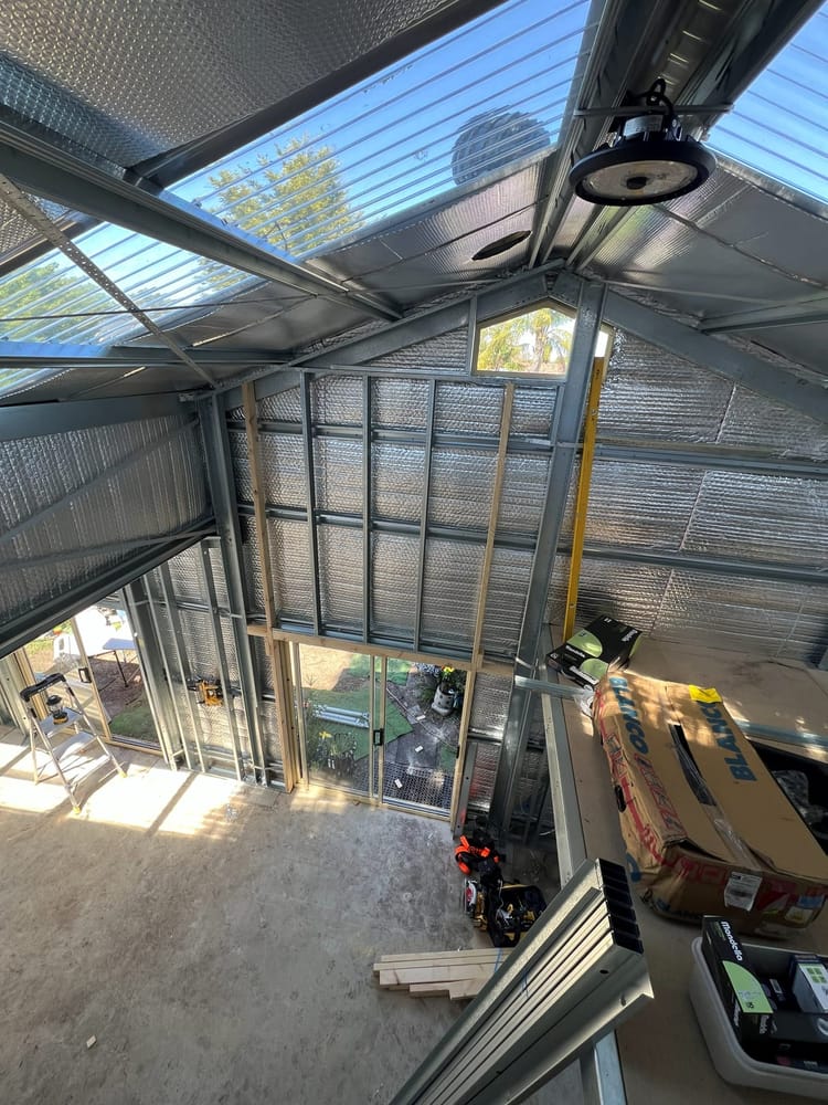 Interior of a shed with steel framing and roof structure exposed