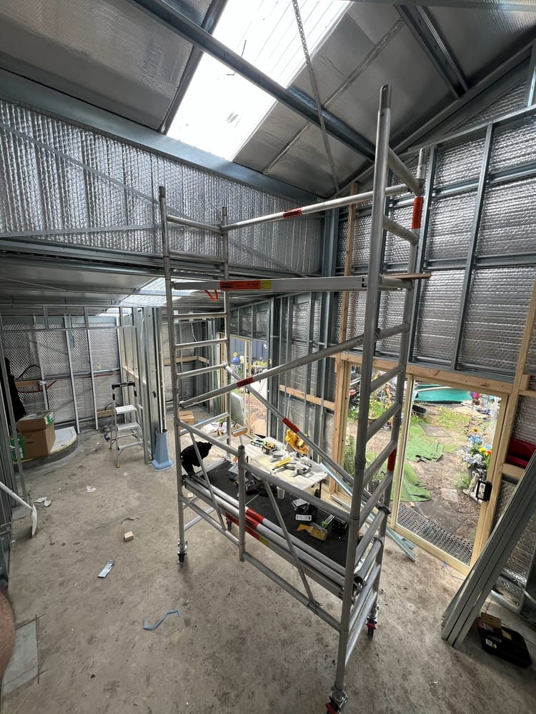 Shed conversion further along, with framing complete and trestles set up