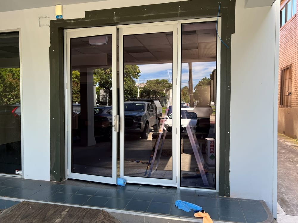 New shopfront entry doors installed in a commercial frontage