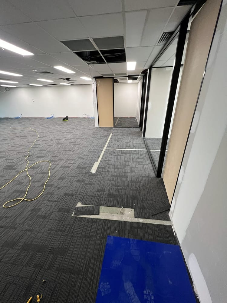 Completed office fit-out corridor with panelled walls and new doors
