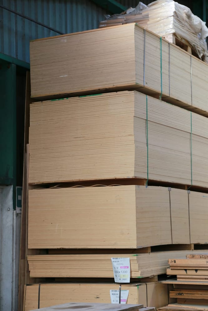 Packs of MDF sheets stacked and strapped in a warehouse