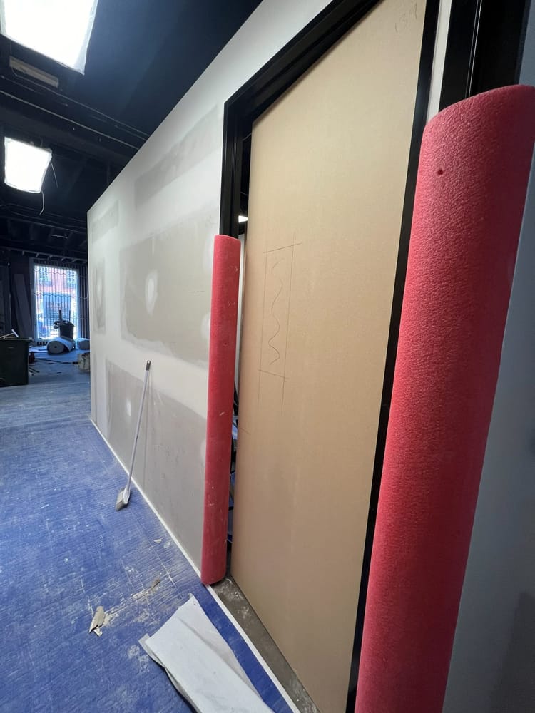 Wall panelling being set out and fitted in a commercial space